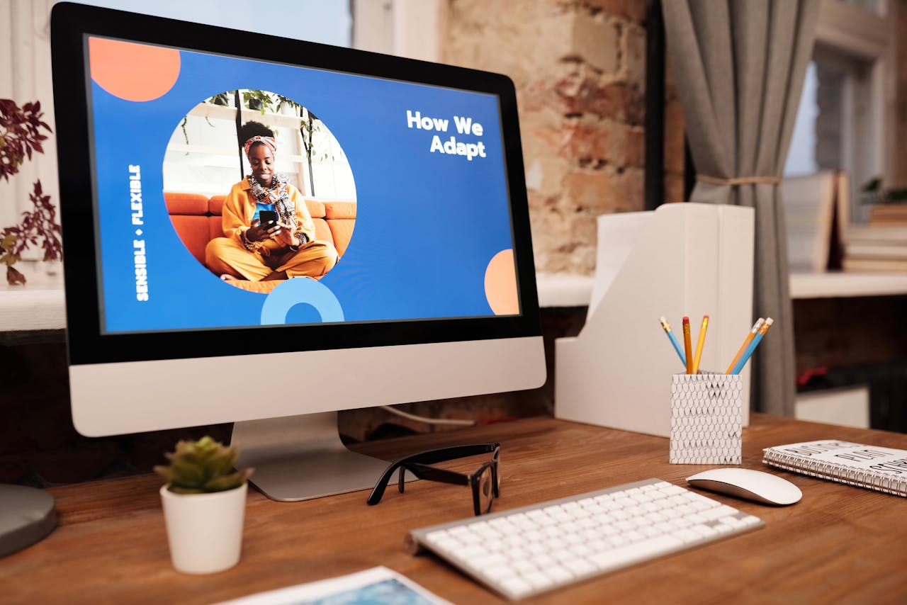 About A stylish office desk setup with a computer screen displaying a digital presentation in a cozy home office.
